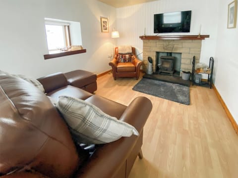 Cosy multifuel stove for chilly evenings. 49&rsquo; smart tv with Sky and Prime included. | Riverside Cottage, Drumnadrochit, near Loch Ness