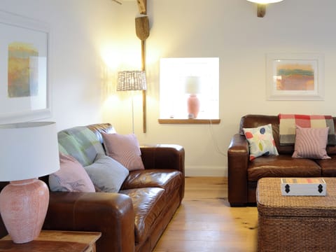 Wood-floored living area with feature wood burner | The Byre - Rispond Estate, Rispond, near Durness