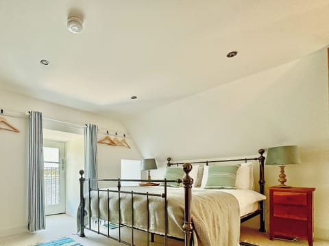 One of the top floor bedrooms, with balcony (historically for a hoist for the catch) | The Fish House - Rispond Estate, Rispond, near Durness