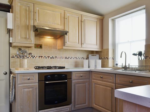 The tiled floor in the dining area extends into the well equipped kitchen | Oak Lea, Keswick