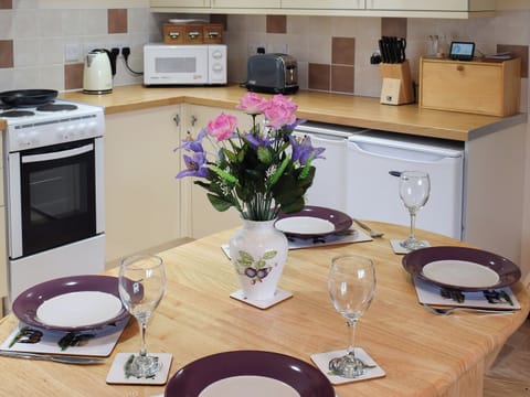 Dining table comfortable set for four guests | Sycamore Cottage, Borrowby, near Staithes