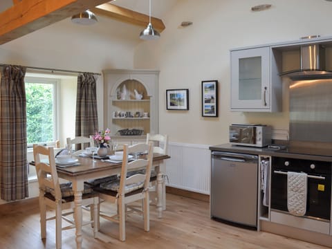 Elegant dining area and adjacent kitchen | Brow View Cottage, Ravenstonedale, near Kirkby Stephen