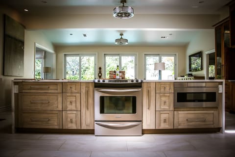 Well equipped for dining in! Prepare a meal overlooking the den, pool, and yard.