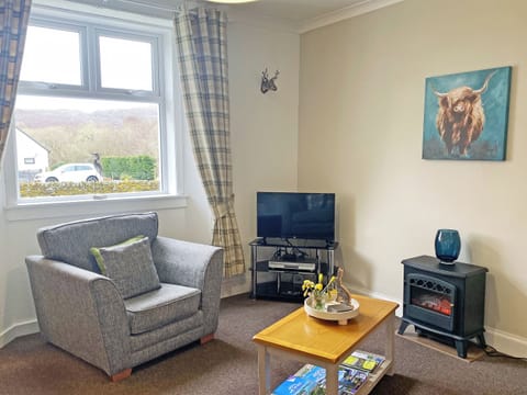 This very comfortable and cosy sitting room features a stove effect electric fire and freesat flat screen<br />tv. The perfect place to enjoy and cup of tea or lovely glass of wine | Kirnan Cottage, Kilmichael Glassary, near Lochgilphead