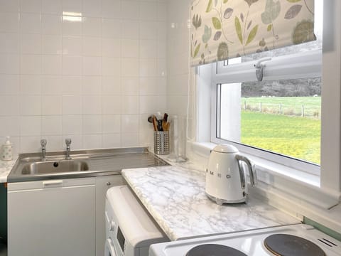 Compact, fully equipped kitchen leading through to breakfast room and walk in spacious pantry offering good storage areas | Kirnan Cottage, Kilmichael Glassary, near Lochgilphead