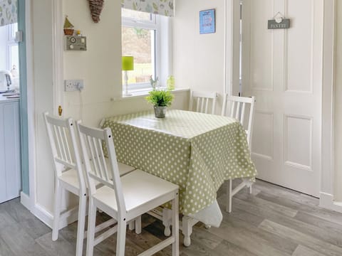 Bright dining area with extendable table, leading through to quaint pantry which offers good storage area and compact kitchen | Kirnan Cottage, Kilmichael Glassary, near Lochgilphead