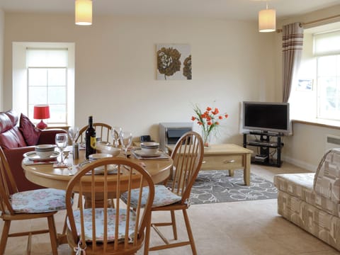 Convenient dining area within an open plan living space | Pennan Lodge - Nethermill Cottages, Pennan, near New Aberdour