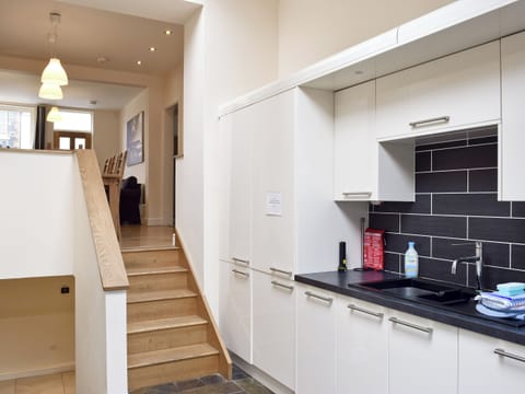 Fitted kitchen with stairs down to lower level | Falcon Crag, Keswick