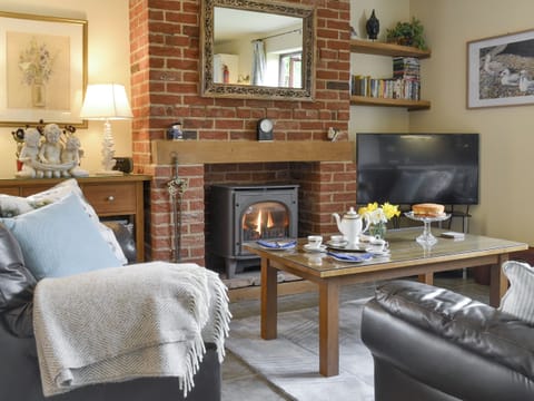 Welcoming living area with wood burner | Riverside Cottage, Old Costessey