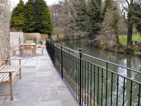 Terrace overlooking river | Herons&rsquo; Weir - Jeffries Mill Cottages, Spring Gardens, Frome
