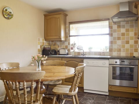 Well-equipped kitchen with dining area | Bodwi Isaf - Bodwi Farm Cottages, Near Abersoch