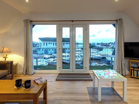 Spacious living room with French doors to balcony | Heron - Daisy Broad Lodges, Wroxham