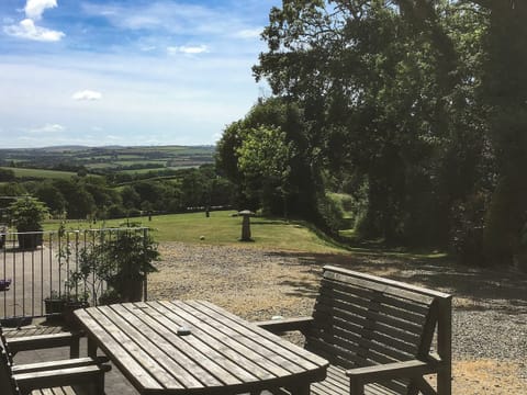 Relax and enjoy the scenery from the patio | The Stable, Lower Shipen - Brazzacott Cottages, North Petherwin, near Launceston