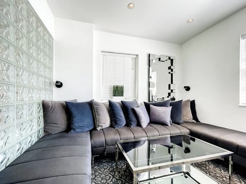 Relax in the bright living room with a large 75-in Smart TV and an oversized window offering a partial city view, away from any street noise.