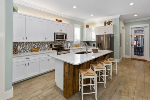 Full kitchen and direct access to the backyard, pool and grilling area.