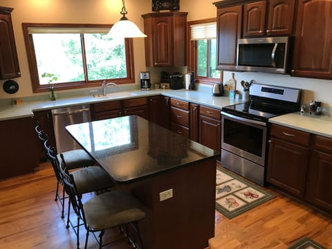 Fully equipped kitchen with new appliances and granite island