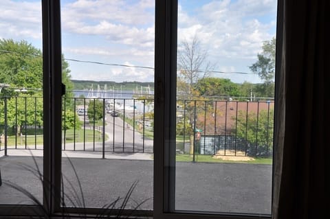 View out balcony door overlooking marina and beach