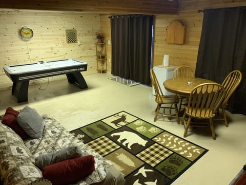 Basement from stairs. Dart board (adults only), Air hockey/ping pong/card table.
