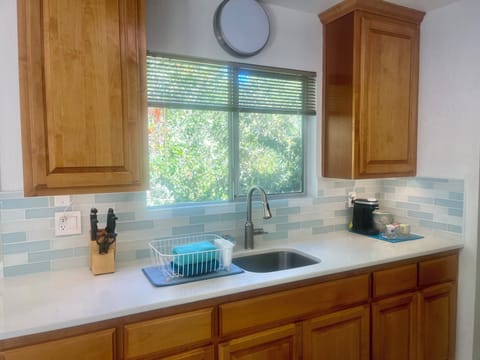 Well equipped kitchen: Dishes, silverware and a Brita water pitcher.