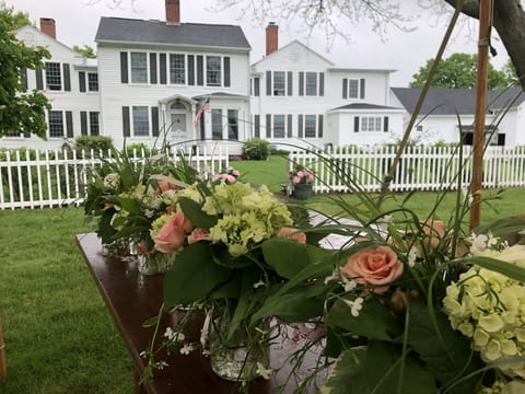 Front of house before family wedding with flower arrangements.