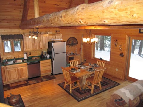 Kitchen with stainless steel appliances and sliding doors to deck