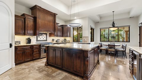 Beautiful kitchen with wood cabinetry, granite counters & spacious island!