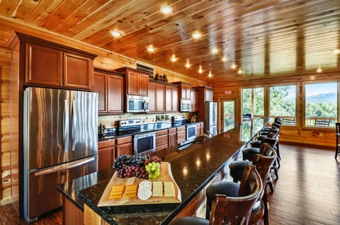 Kitchen complete with a long center island with bar seating and modern appliances.
