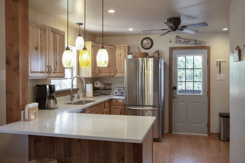 Newly remodeled kitchen fully stocked with cookware, utensils and serving ware.