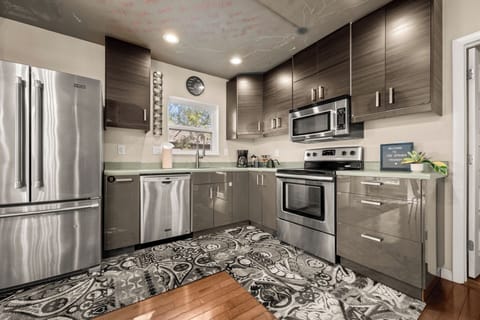 Fully stocked kitchen with electric range, dishwasher, stainless appliances