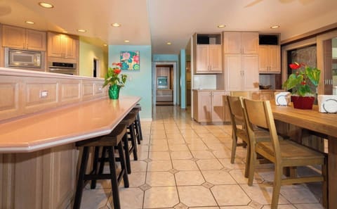 View of kitchen bar, hallway, and dining area