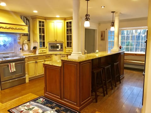 Breakfast bar with granite countertops and custom cabinetry