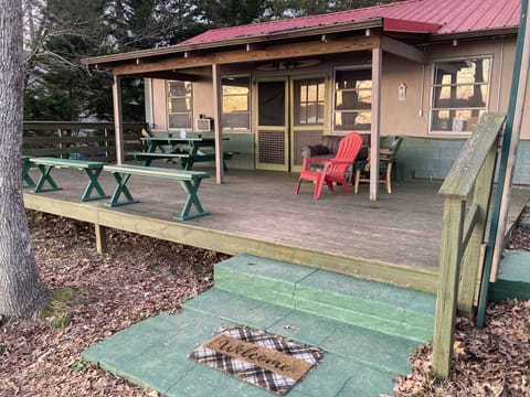 The deck/entrance to cabin, facing the lake