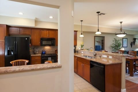 Full kitchen with breakfast bar, granite counters, and modern appliances