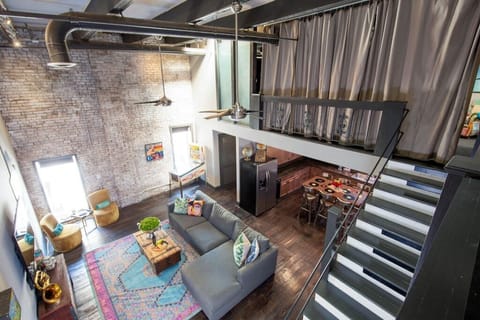 Upstairs Primary Bedroom with Privacy Curtain Overlooking Living Area