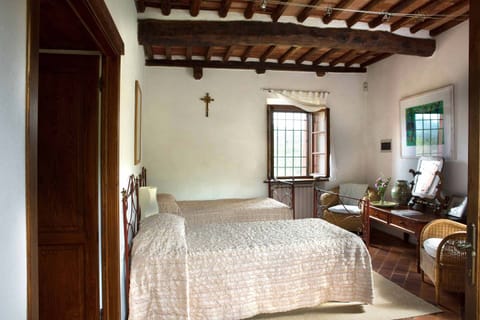 Airy twin bedroom with chestnut beams, cotto floors. Views east, south & west