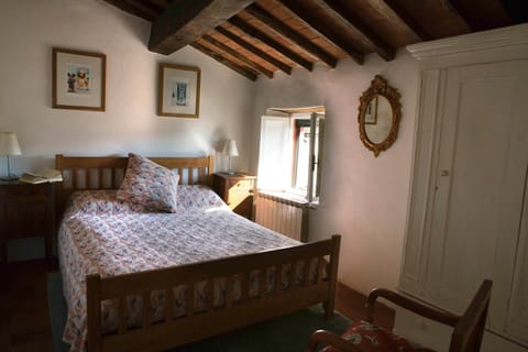 Double bedroom, chestnut beams, cotto floors views over pool & hills