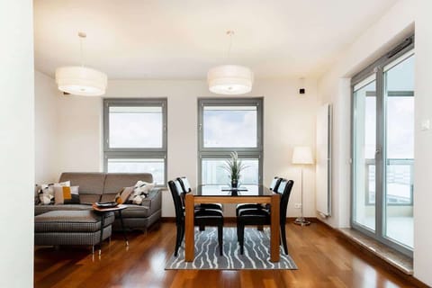 Living and dining area with a gray sofa, a dining table creating a cozy and unified look.