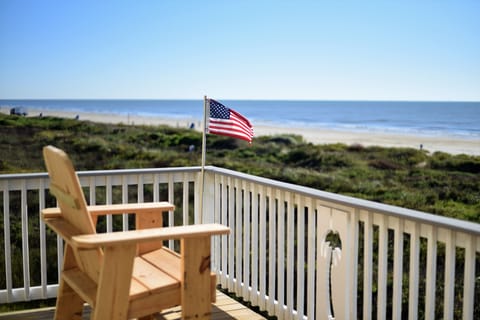 Unmatched view. Four tall wooden chairs, table and two rocking chairs provided.