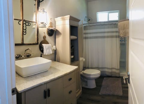 The bathroom is stocked with extra towels and soaps.