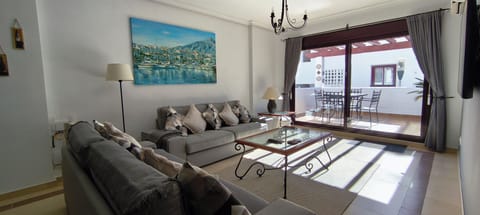 Spacious lounge with seating for six people, A/C, 55" wall mounted TV.