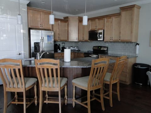 Kitchen with large granite island, sink is in the island