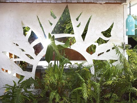 Mirrored sun mural off spa lights red at night while you relax in the spa.