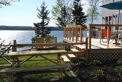Deck with grill, new large rectangular table with 10 chairs, umbrella. 