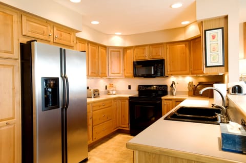 Kitchen has lots of cabinet and pantry space with full under cabinet lighting.