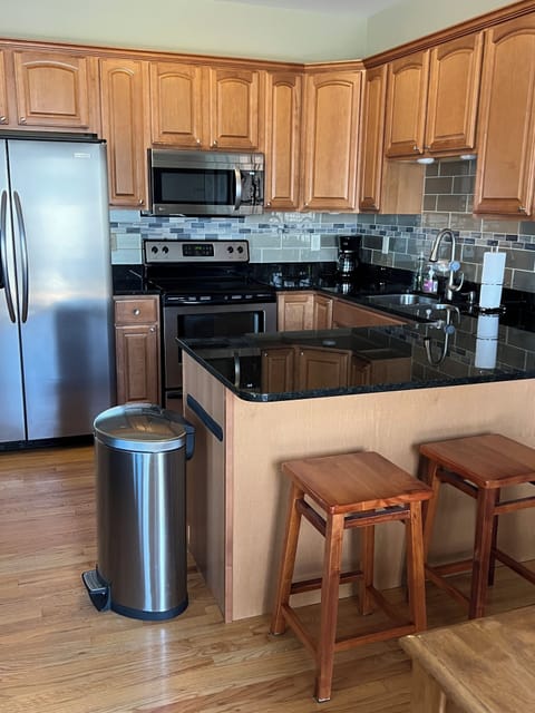 Modern kitchen with granite counters and stainless appliances.