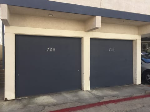 Garage off back alley with one parking spot and stacked washer/dryer.