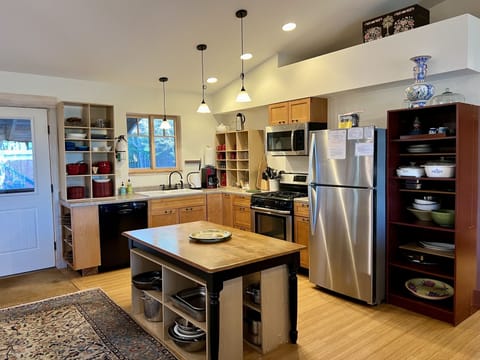 Upstairs kitchen with dishwasher, oven, microwave and fridge, freezer