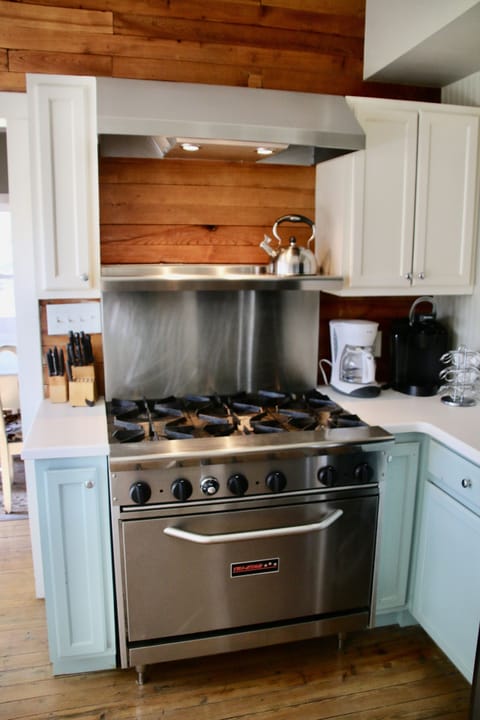 Commerical 6 burner gas stove with oven, tea kettle and 2 coffee makers.
