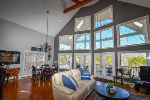 Main level living room with wood burning fireplace and tv