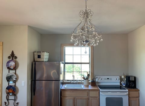 View of kitchen- amenities include refrigerator, stove, microwave, coffee maker